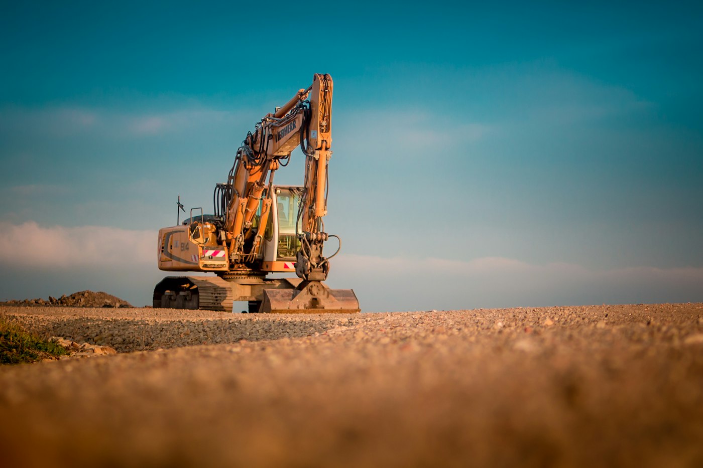 An excavator on a construction site at dusk